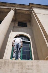 a man standing on the steps of a building